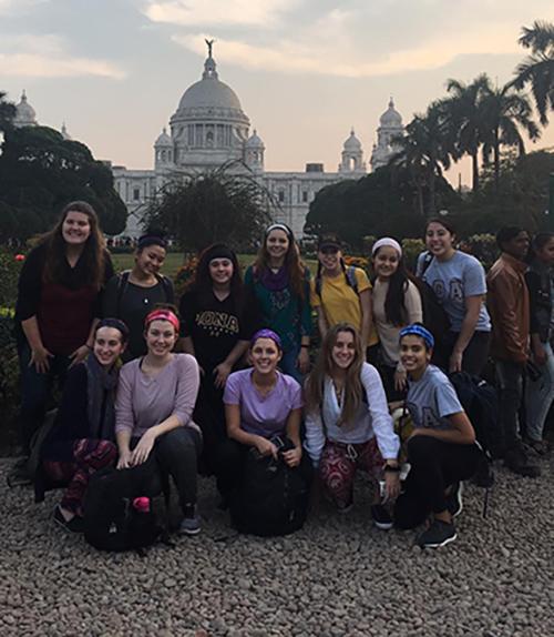 Students pose in front of a building in Kolkata, India during a Winter 2018-19 trip.