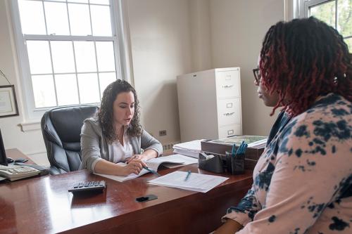 An admissions counselor helps a graduate student create her schedule.