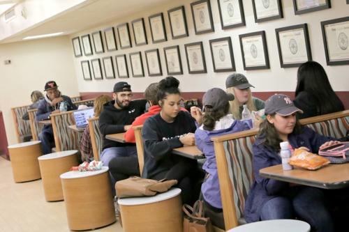 Students sit in booths eating food in Vitanza Commons.