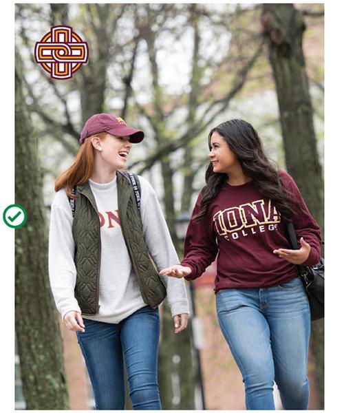 Two students walk on campus with the Iona College Celtic knot icon in the top left corner.