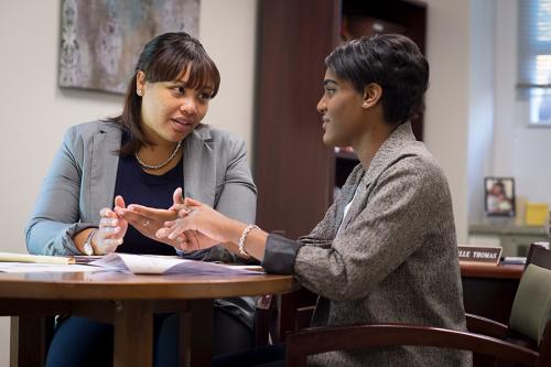 A student reviews her resume with a staff member from the Office of Career Development.