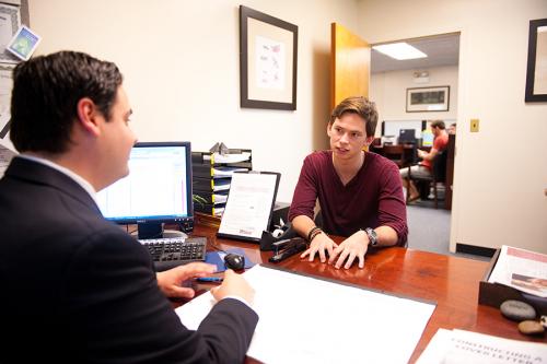 A student talks across the desk with a staff member from the Office of Career Development.