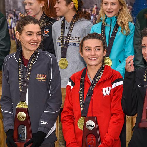 Female athletes pose with their NCAA trophies.