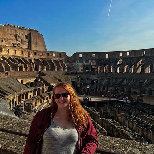 A student stands in the Colosseum in Rome, Italy.