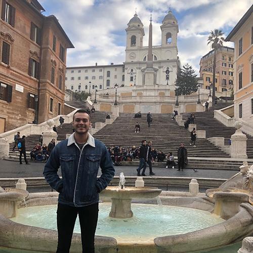 An Iona stands in front of a fountain in Rome, Italy.