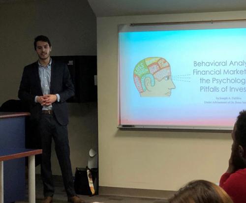 Joe DaSilva delivers his thesis presentation on the Behavioral Analysis of Financial Markets and the Psychological Pitfalls of Investors.
