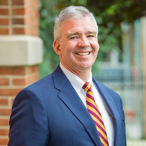Iona University President Seamus Carey, Ph.D. outside of the Ryan library.