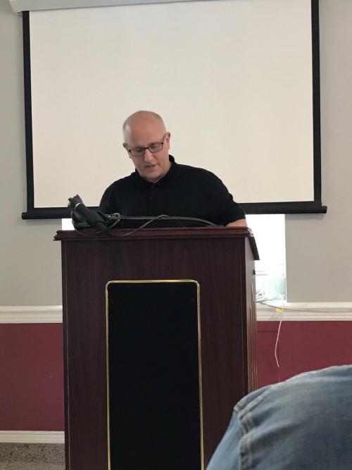 Dean Defino at the podium from Iona University English's Twitter account