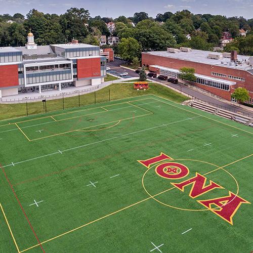 Aerial shot of Mazzella field with Hynes Athletics Center and LaPenta Student Union in the background.