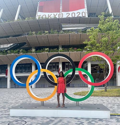 Mary Omatiga stands in front of the Olympic rings in Tokyo, Japan.