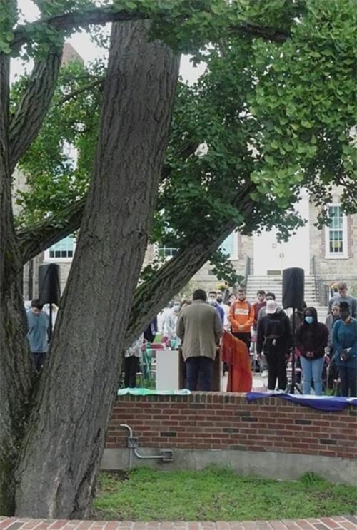 Students in prayer by the tree.