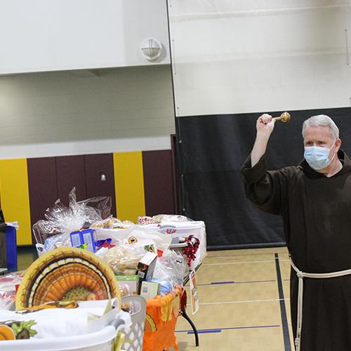Fr. Mulvey blesses the baskets at the 2021 Thanksgiving Baskets Ceremony.