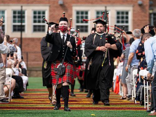 The pipe band marches at the 2021 Commencement.