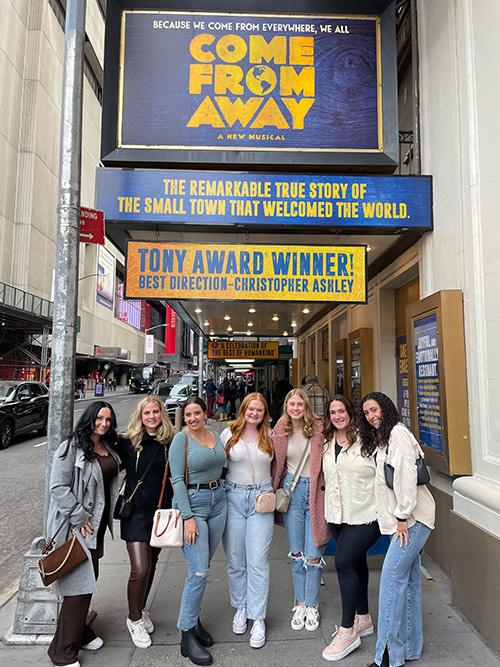 A group of students attending Come From Away.