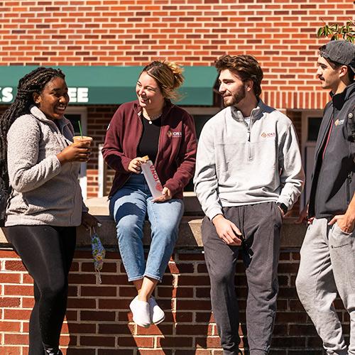 Students enjoy coffee outside of Starbucks.