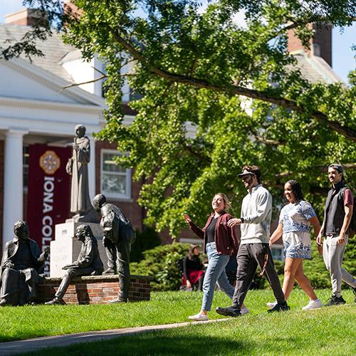 Students walking on campus near McSpedon Hall.