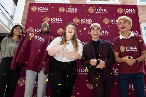 Five students celebrate the announcement of Iona University.