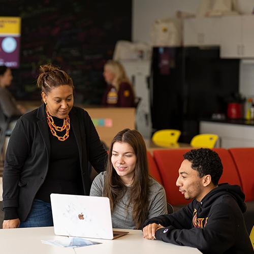 Lendynette works with two students at the Hynes Institute.