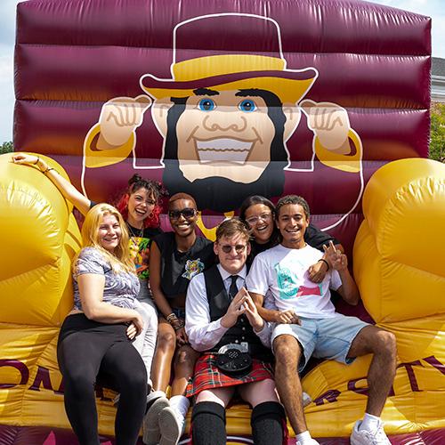 Students on the inflatable chair at the Iona birthday party.