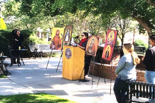 Dr. Christina Carlson reads Icon Dedications while Dr. Andruk observes.