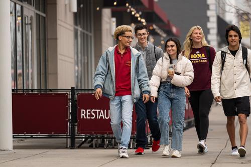 Iona students walk down North avenue by the Mirage.