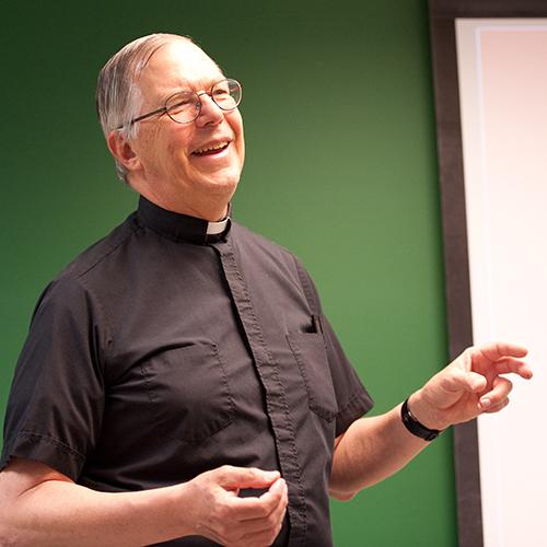 Br. Novak smiling as he teaches a class.