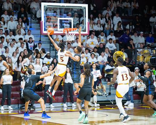 Daniss Jenkins dunks on the competition at a men's basketball game.