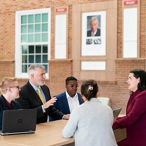 A group of MBA students in the atrium in LSB.