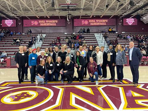 Women's basketball honorees on the Hynes Arena court.