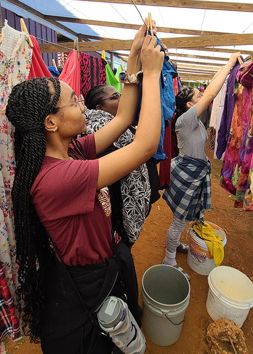 Students helping to hang laundry during the 2023 Jamaica service trip.