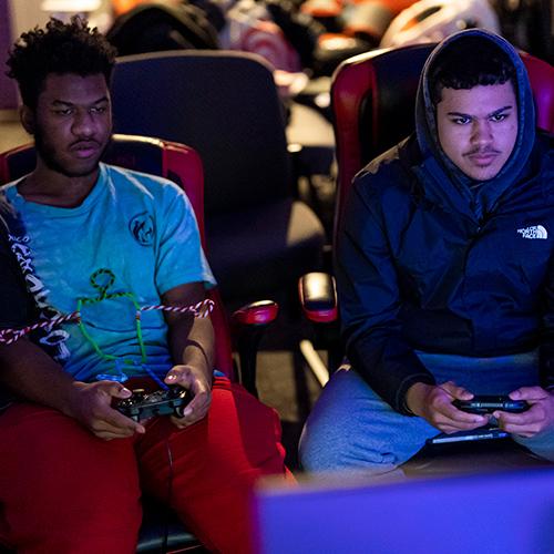 Two gamers concentrate while playing.