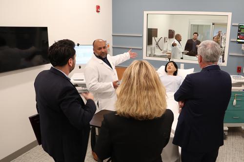 An Iona nursing professor discusses the simulation lab with administrators.