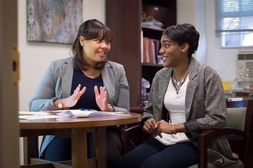 A student and a counselor discuss student loans.