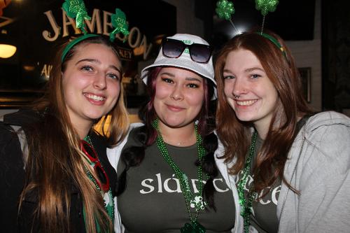 Three young alumni on St. Patrick's Day.
