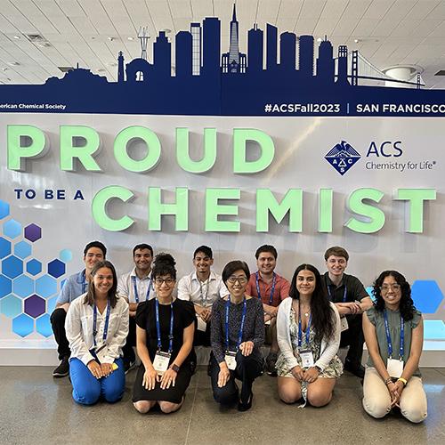 ACS SF Fall 2023 participants in fron the Proud to be a Chemist backdrop.