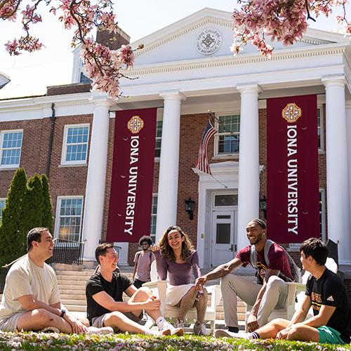 Berrick and friends sit outside of McSpedon Hall and talk.