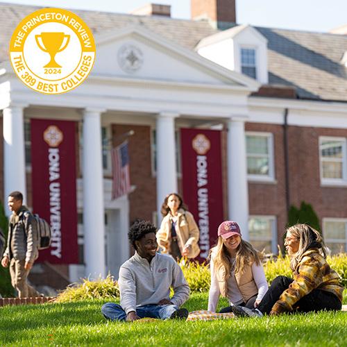 Students sit in the quad outside of McSpedon Hall on a sunny day.