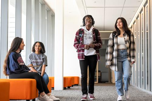 Students walking and talking the LaPenta School of Business.