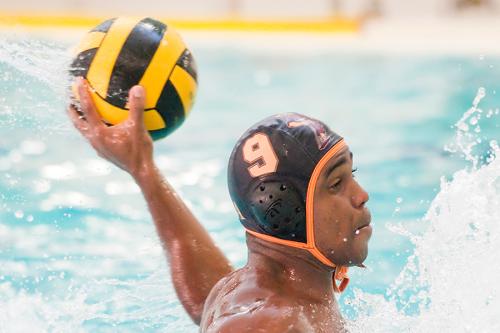 A men's water polo player throws the ball lefty.
