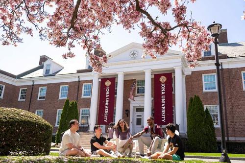 Berrick Jean-Louis and friends sit on the quad and chat.