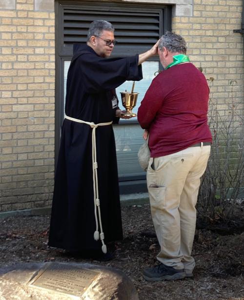 Fr. Vaughn Fayle blessing Michael O’Donnell of Iona Facilities Department.