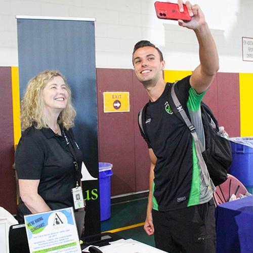 A student takes a selfie at the career fair.
