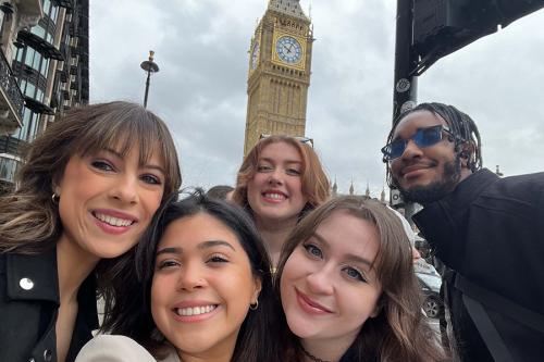 Students smile in front of Big Ben in London, England.