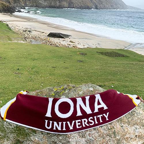 An Iona University scarf on Keem Bay Beach in Ireland.