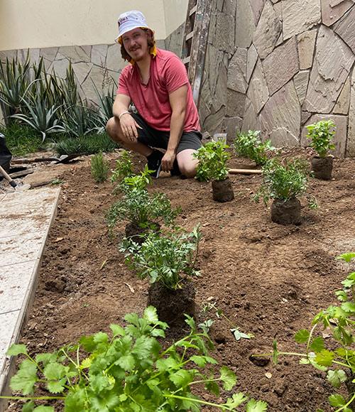 A student works on a garden in Peru.