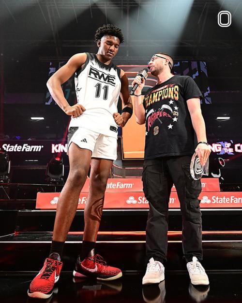 Tom Weingarten interviewing a basketball player.