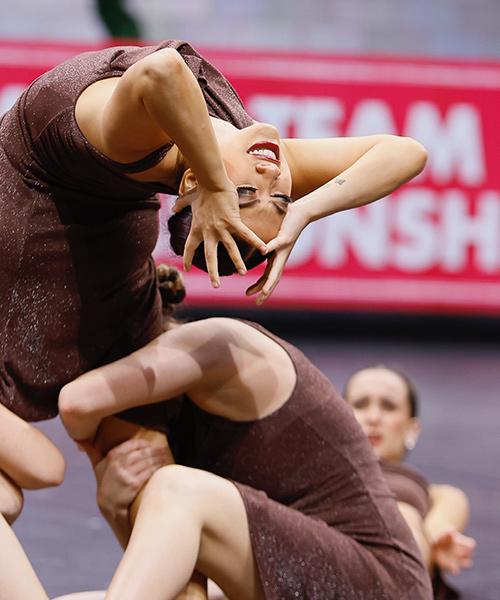 The dance team performs an artistic piece at a competition.