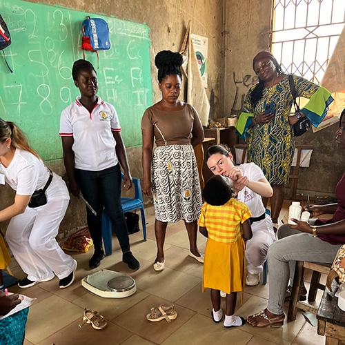 Nursing students administer Vitamin A medication and do growth and development assessments with local public health nurses at a school in Berekum.