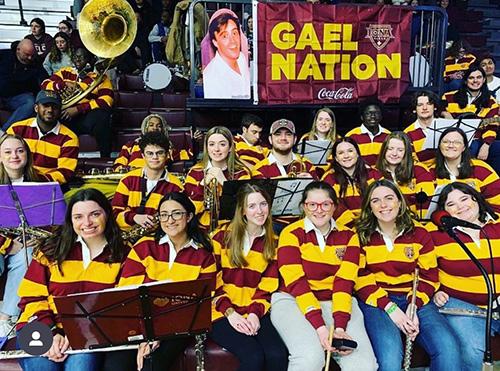 The Pep Band smiles with a Gael Nation flag.