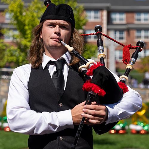 A piper plays on the Murphy Green.